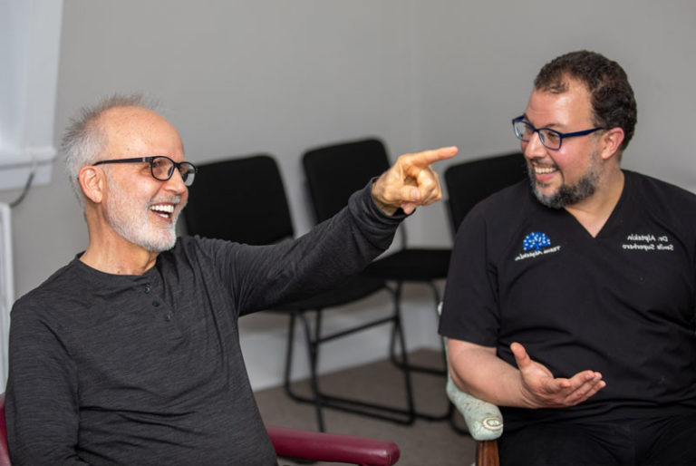 dental implant patient going over smile transformation process with dr altepkin